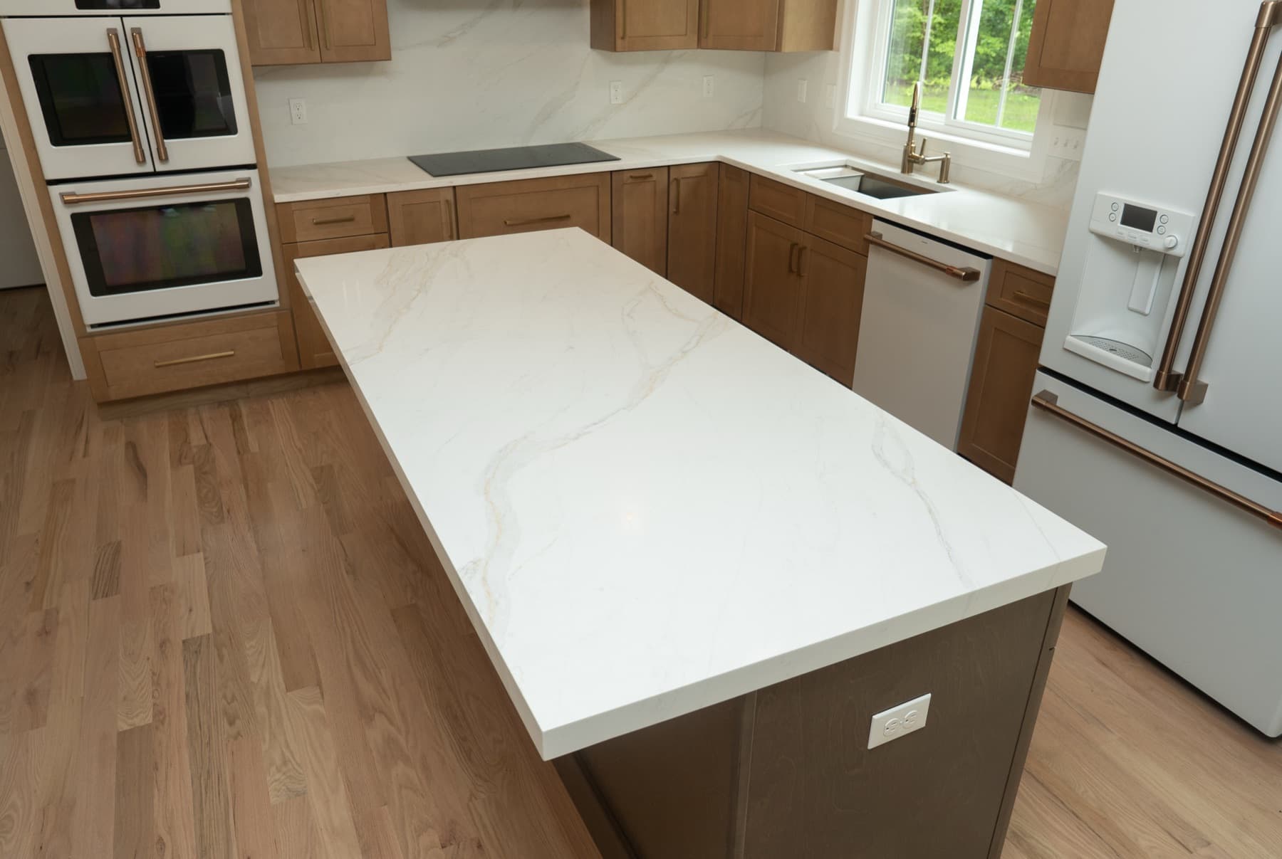 Calacatta Silverlight kitchen island with soft gold veining and white appliances