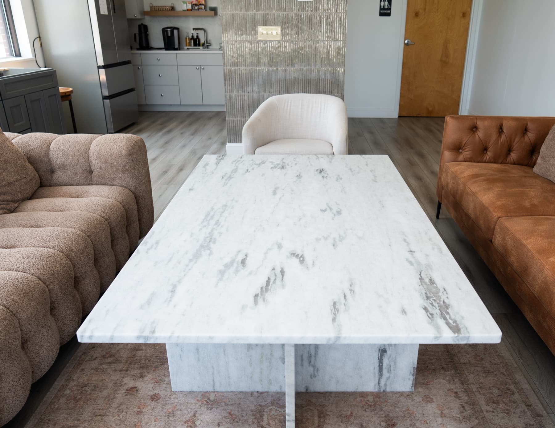 Top view of a custom Fantasy White Leather stone coffee table between two sofas