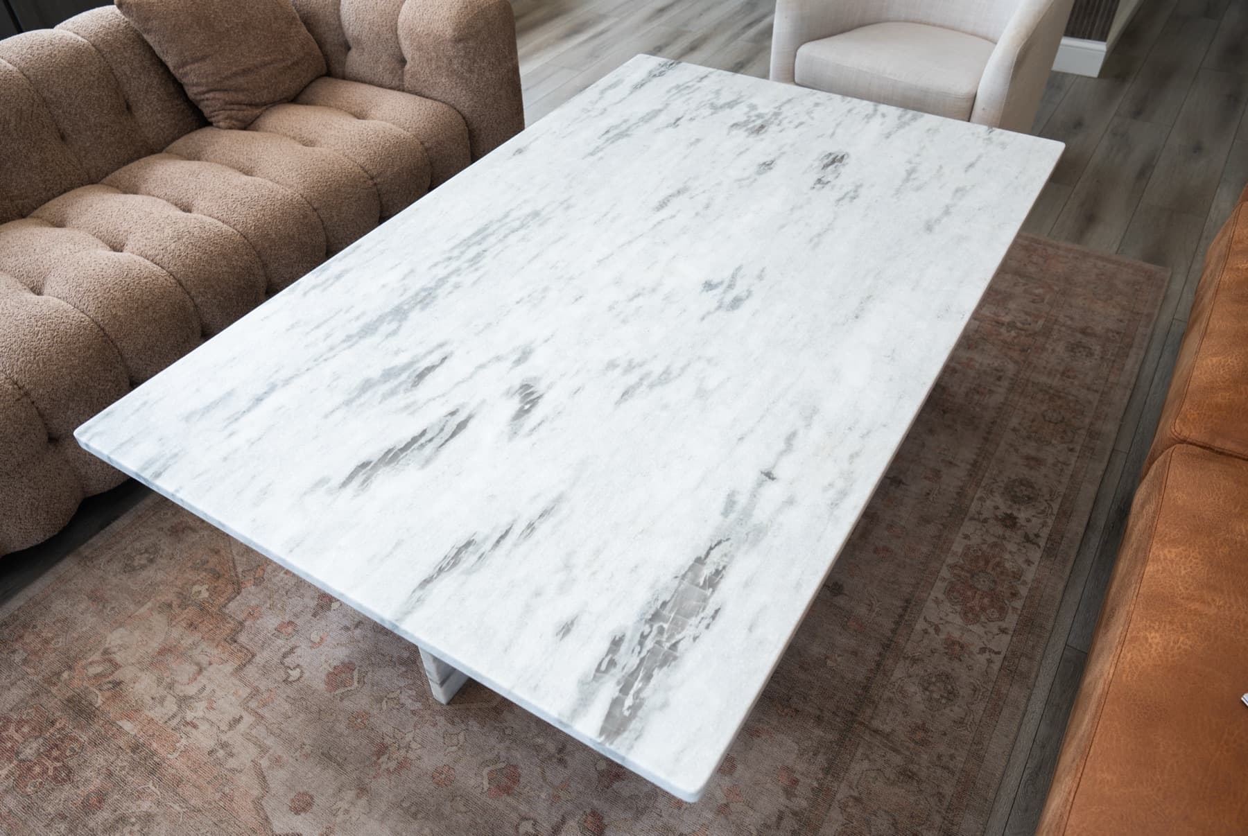 Custom Fantasy White Leather stone coffee table with soft grey movement in a seating area
