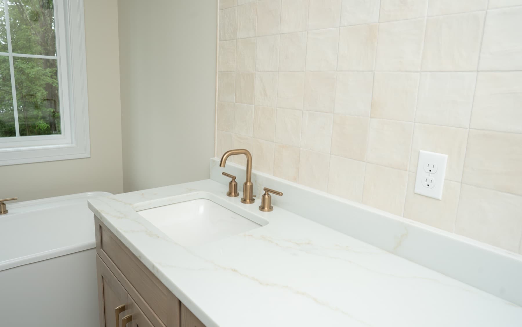 Undermount sink and brass faucet in a Jasper quartz vanity top